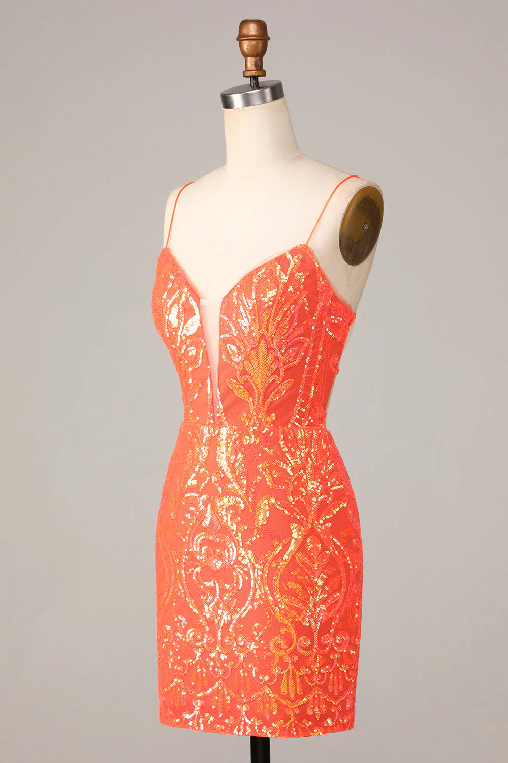 Close-up of the sparkly orange sequin fabric on the bodycon short dress.