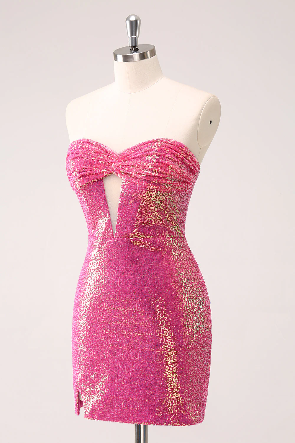 Close-up of the sequin fabric and hollow-out detail on a fuchsia bodycon dress.