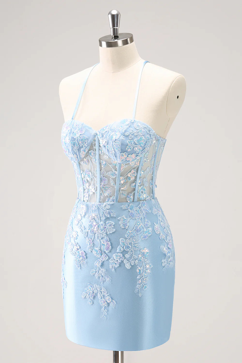 Back view of a sparkly blue bodycon spaghetti strap sequin dress with appliques.