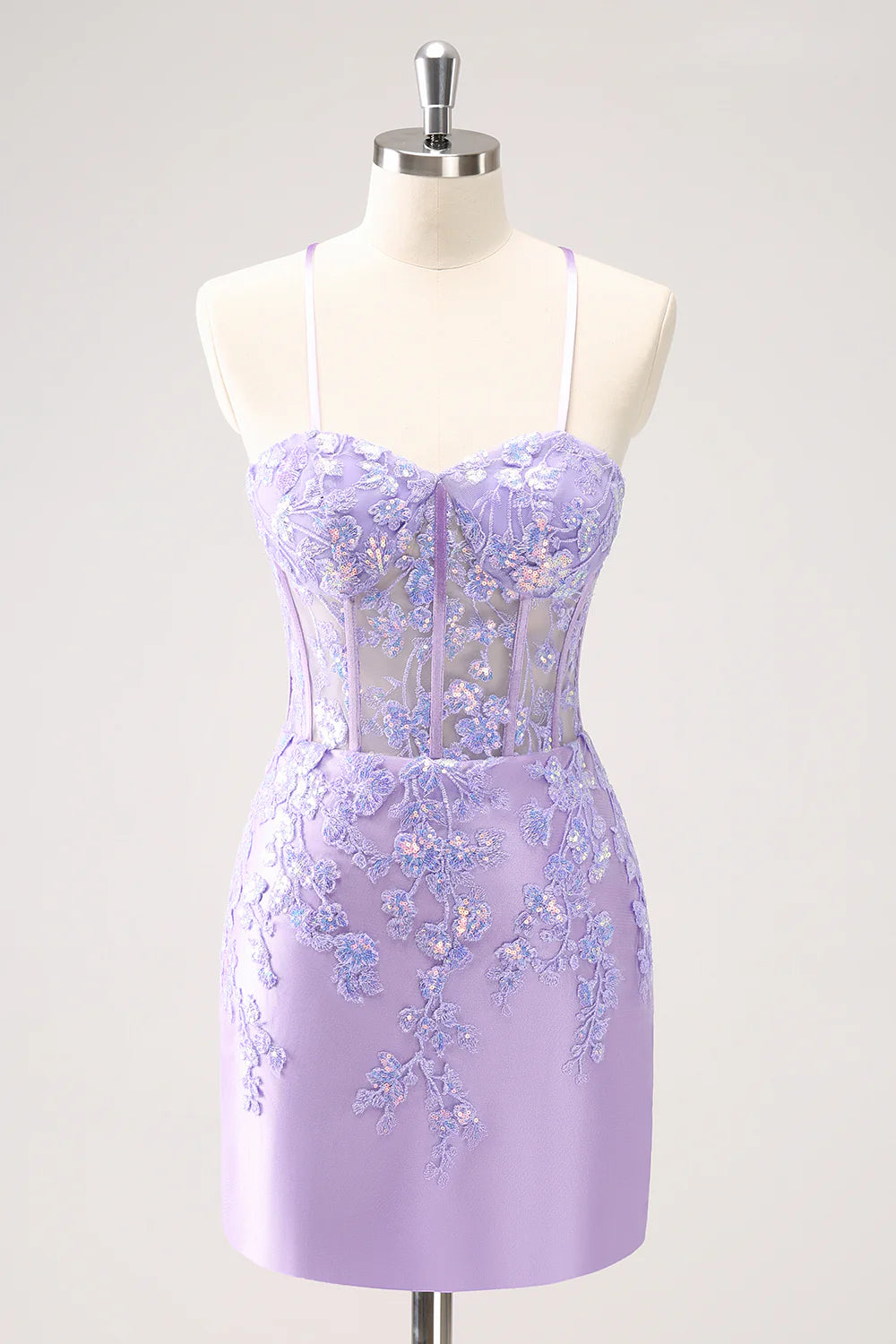 Model wearing a sparkly lilac bodycon spaghetti strap sequin dress with appliques.