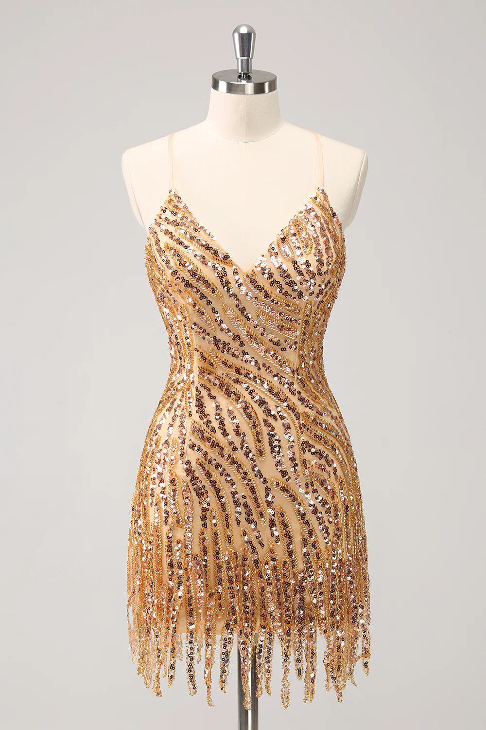Model posing in a dazzling gold sequin bodycon dress.