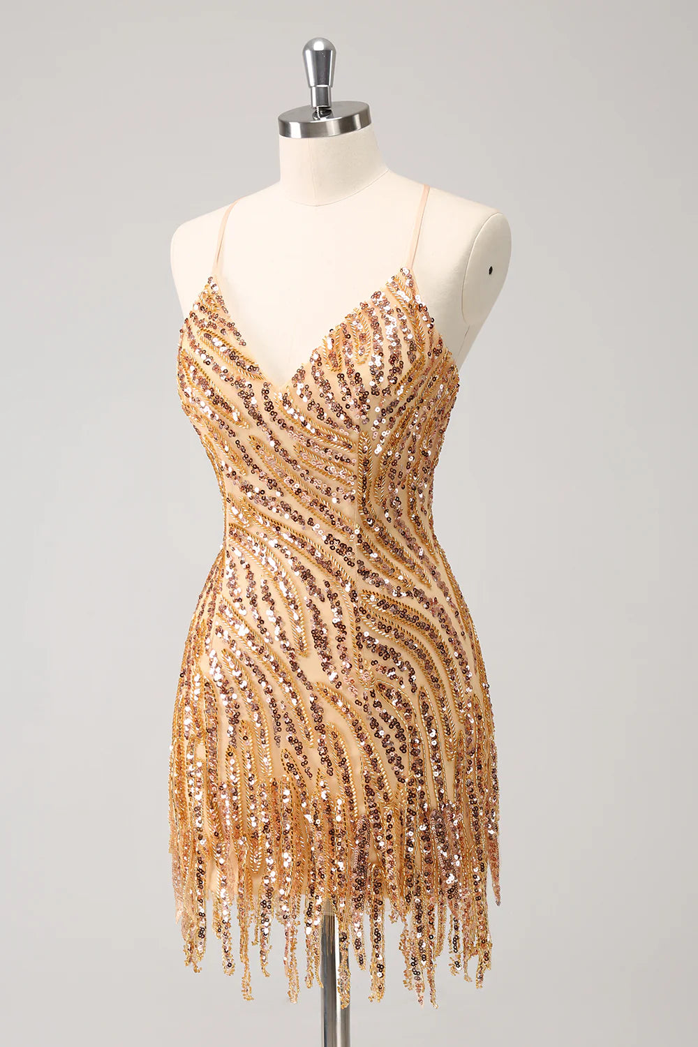 Full length view of a woman in a short gold sequin party dress.