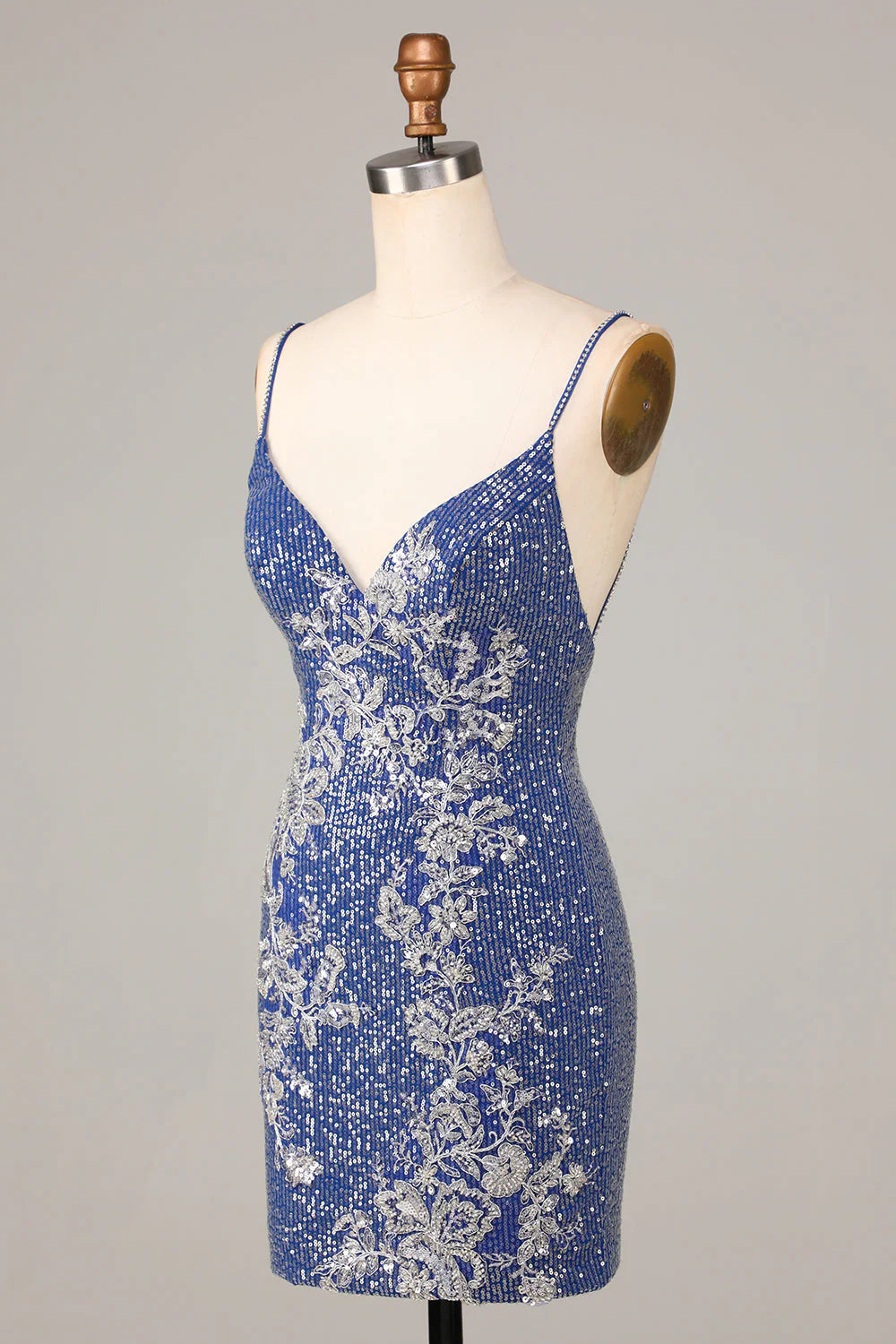 Back view of the dark blue sequined sheath dress with spaghetti straps.