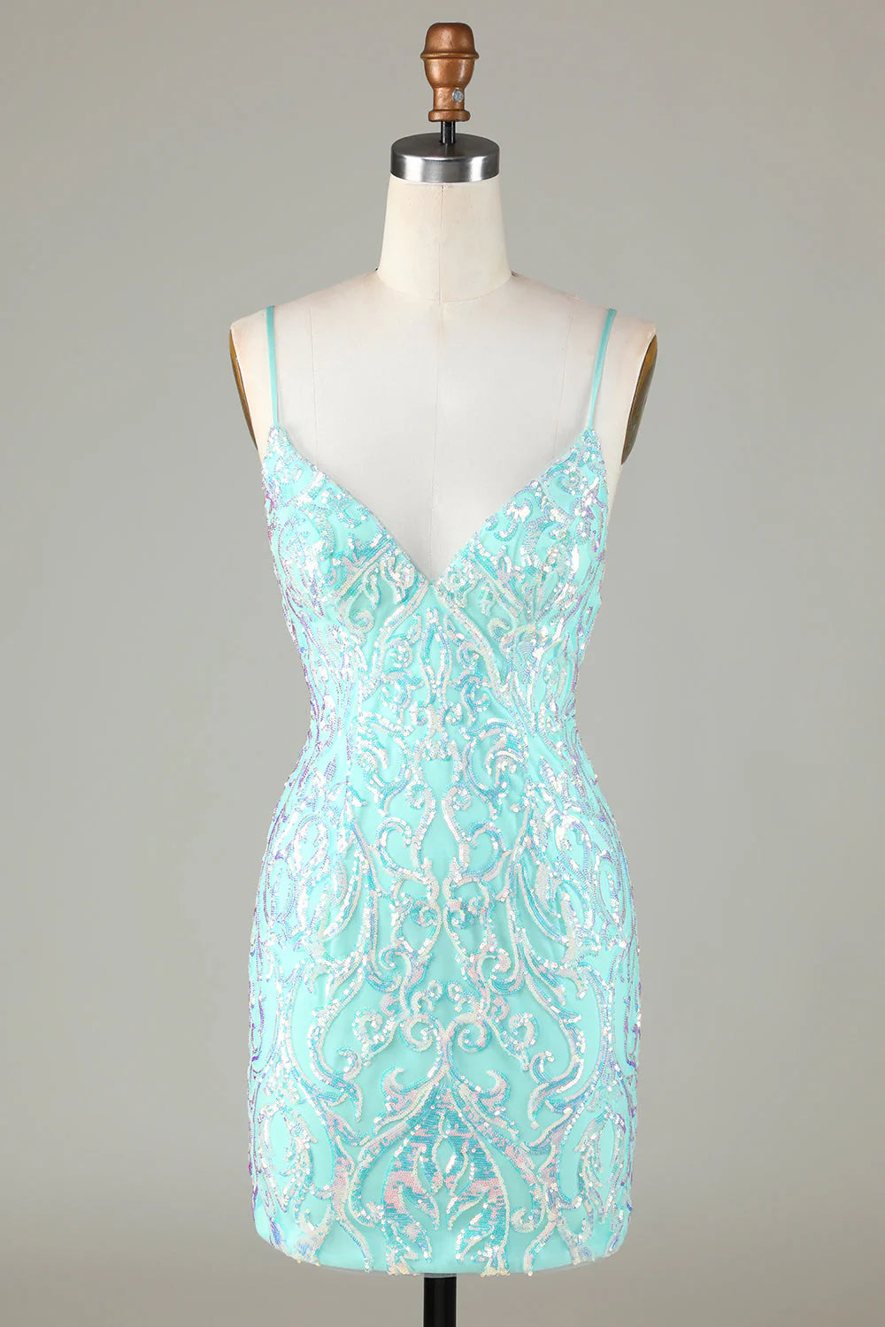 Front view of a sparkly green A-line homecoming dress with spaghetti straps.