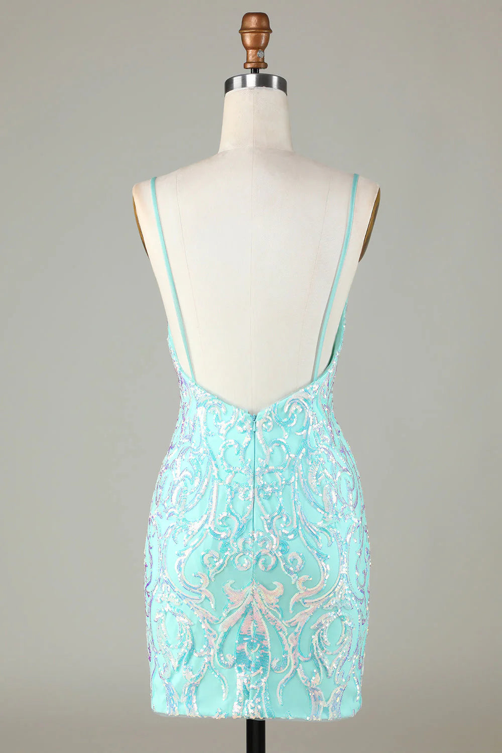 Back view of a sparkly green homecoming dress showing the backless design.