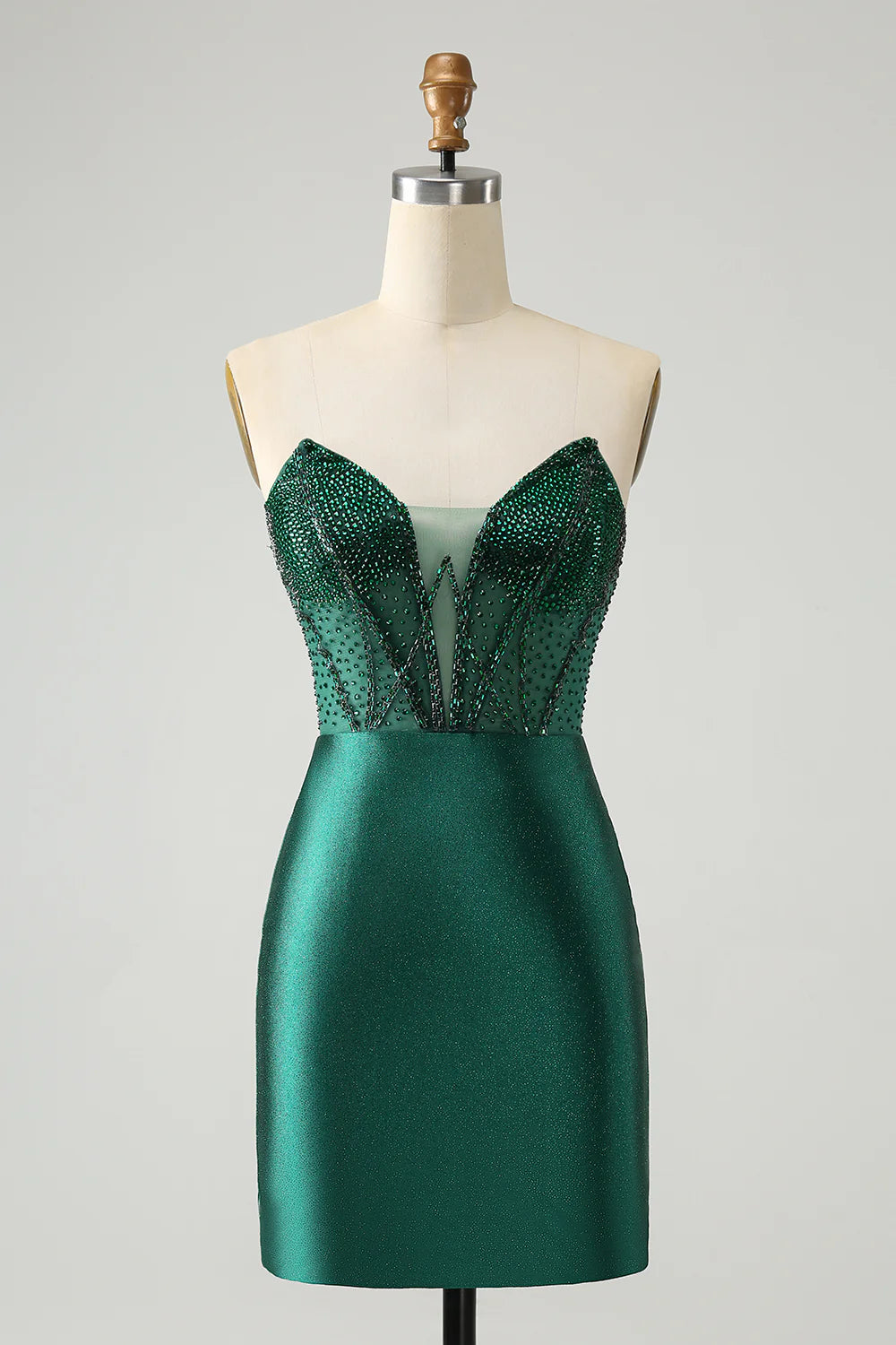 Model wearing a sparkly dark green strapless short homecoming dress with intricate beading.