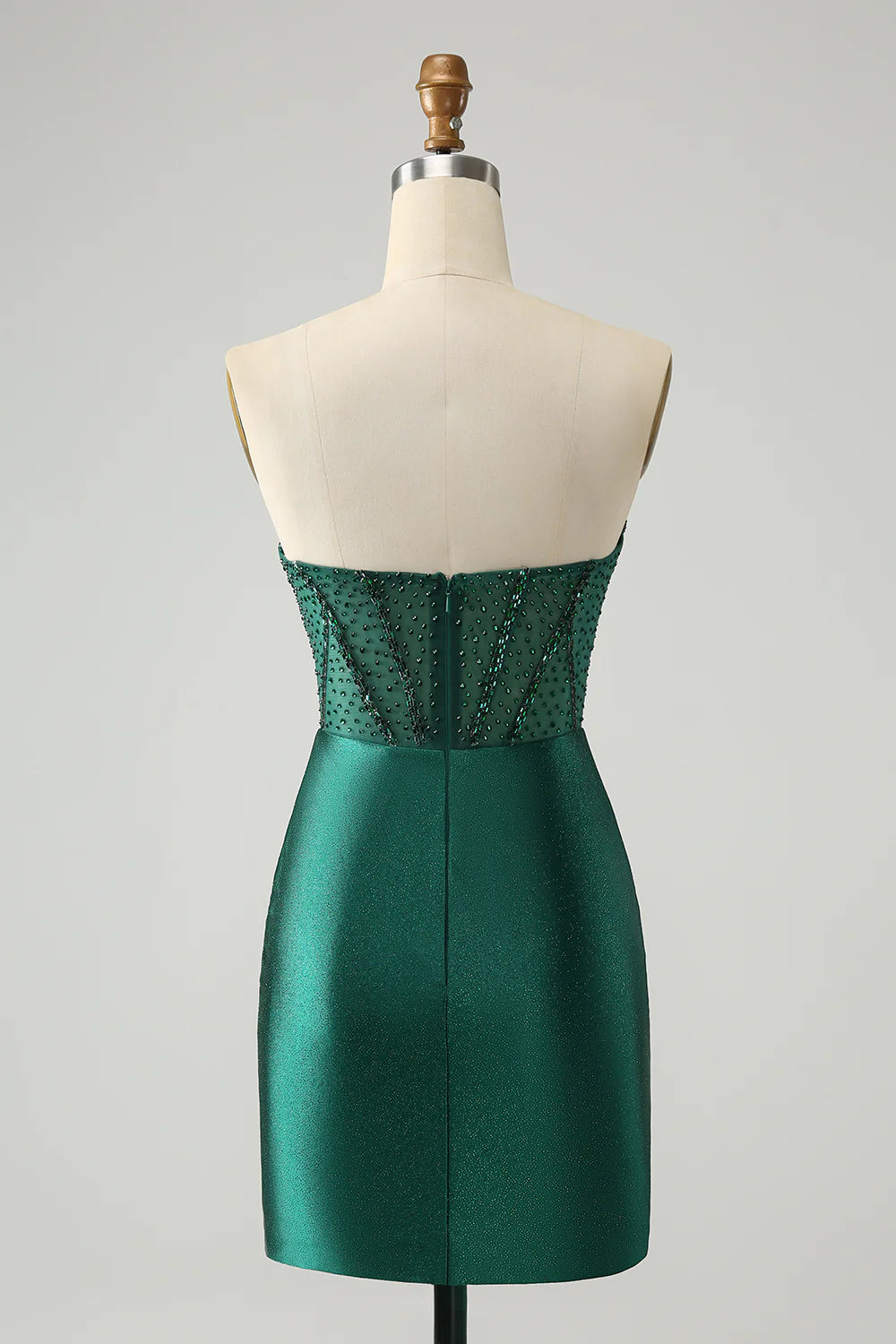 Close-up of the beaded detail on a dark green strapless homecoming dress.
