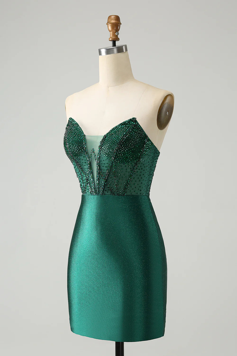 Back view of a model in a fitted dark green sparkly short dress.