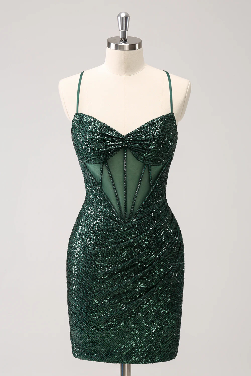Model wearing a sparkly dark green sequin corset homecoming dress with a V-neck and lace-up back.