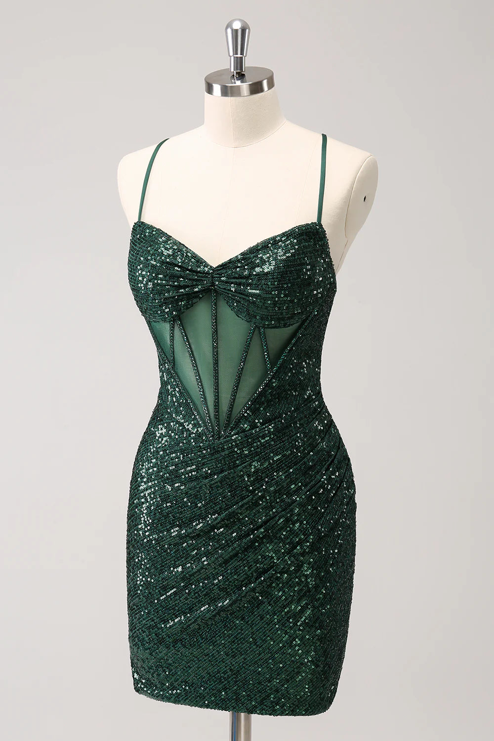Side view of a model in a dark green sparkly sequin short dress.
