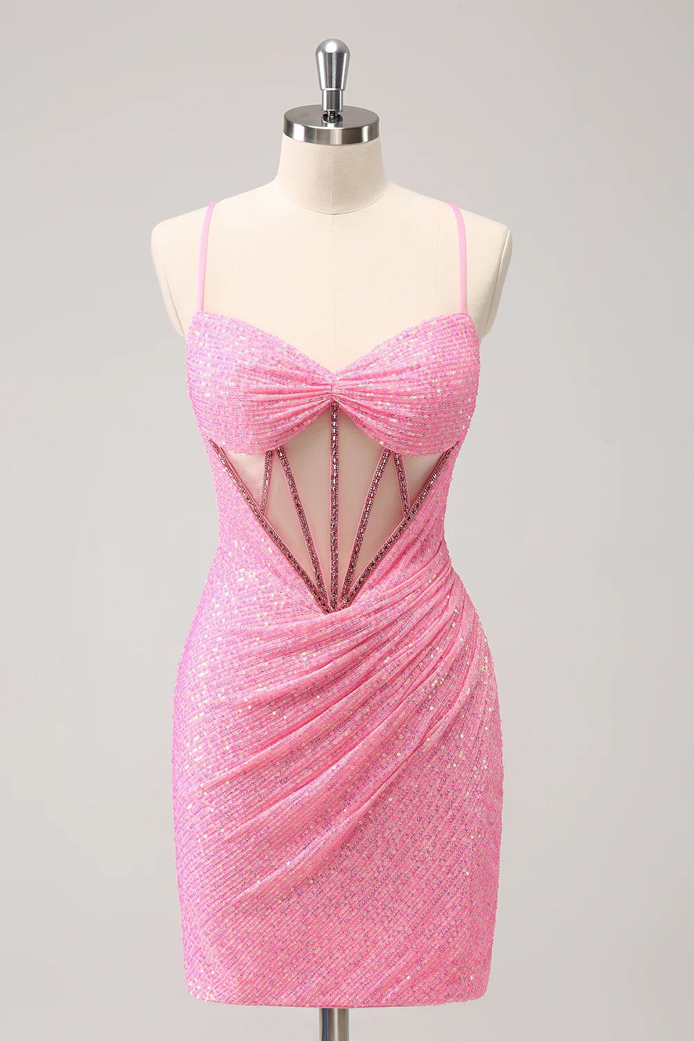 Model wearing a vibrant hot pink sequin corset homecoming dress with a V-neck and lace-up back.