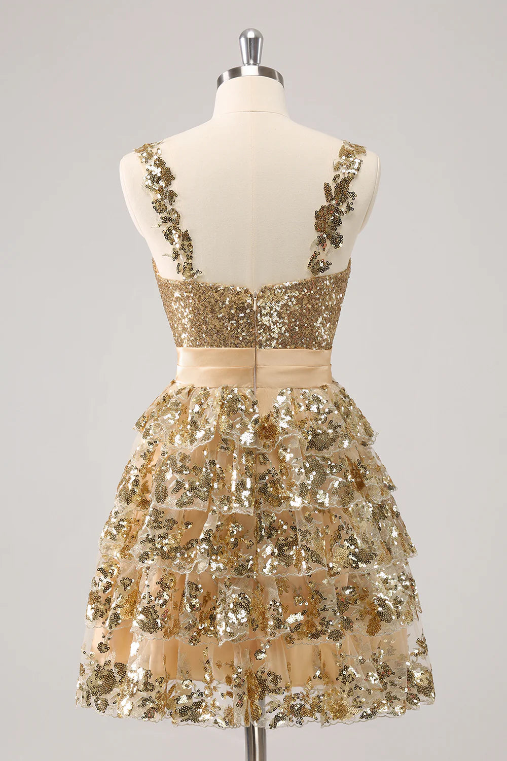 Side view of the golden tiered short homecoming dress, showcasing its A-line silhouette.