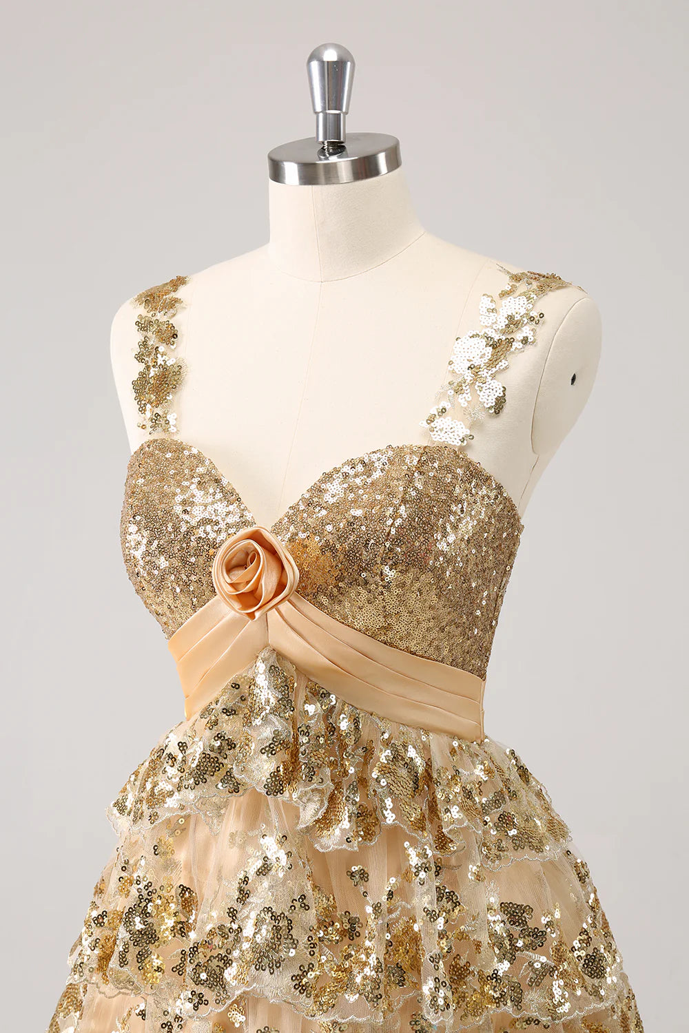 Back view of the strapless golden homecoming dress, highlighting the tiered skirt.