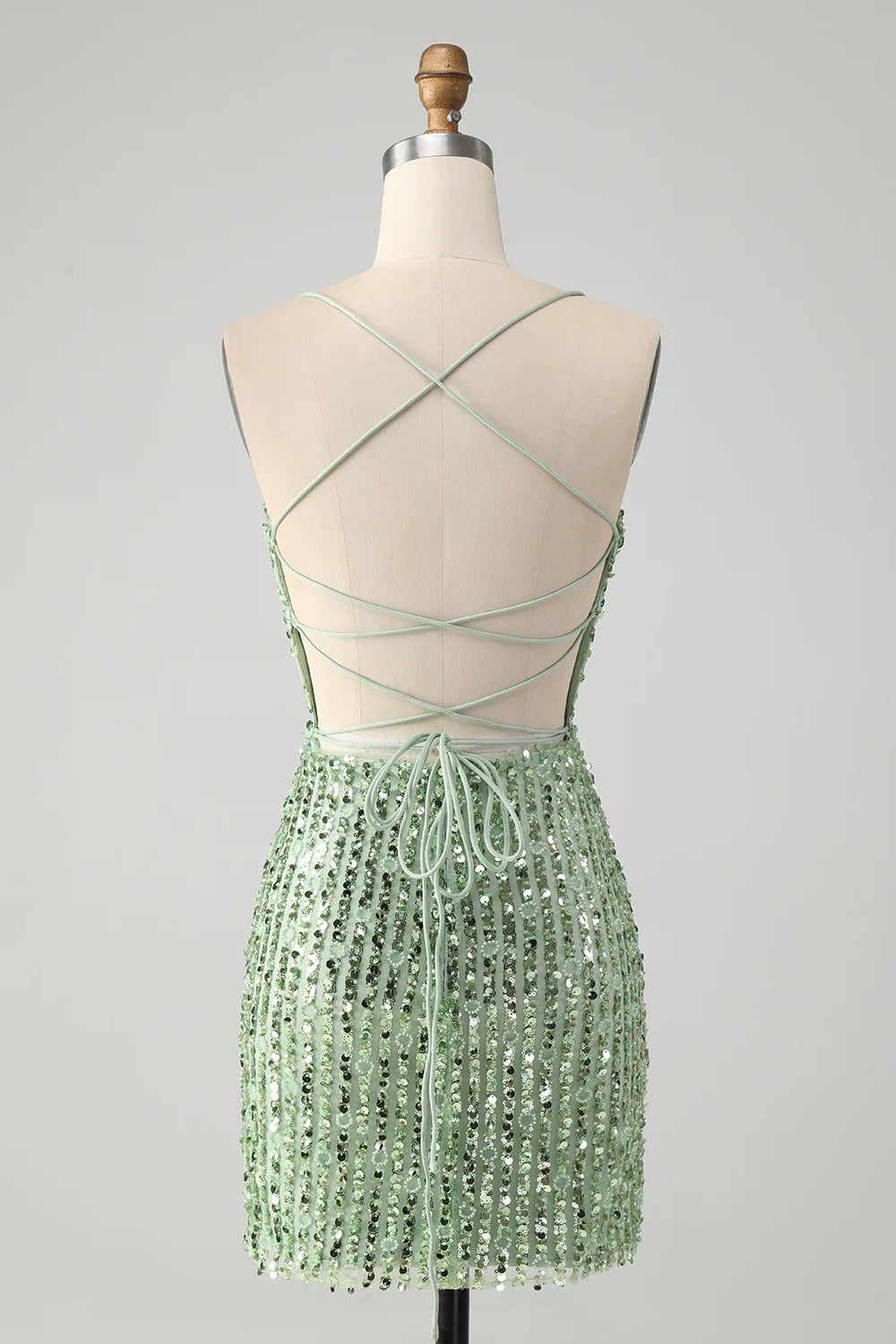 Close-up of the sequined fabric on the green sheath dress.