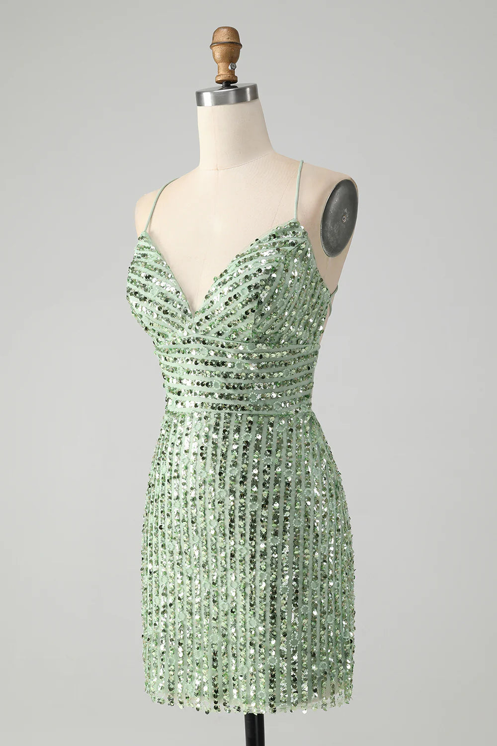 Back view of the green sequin dress showing the criss-cross strap detail.