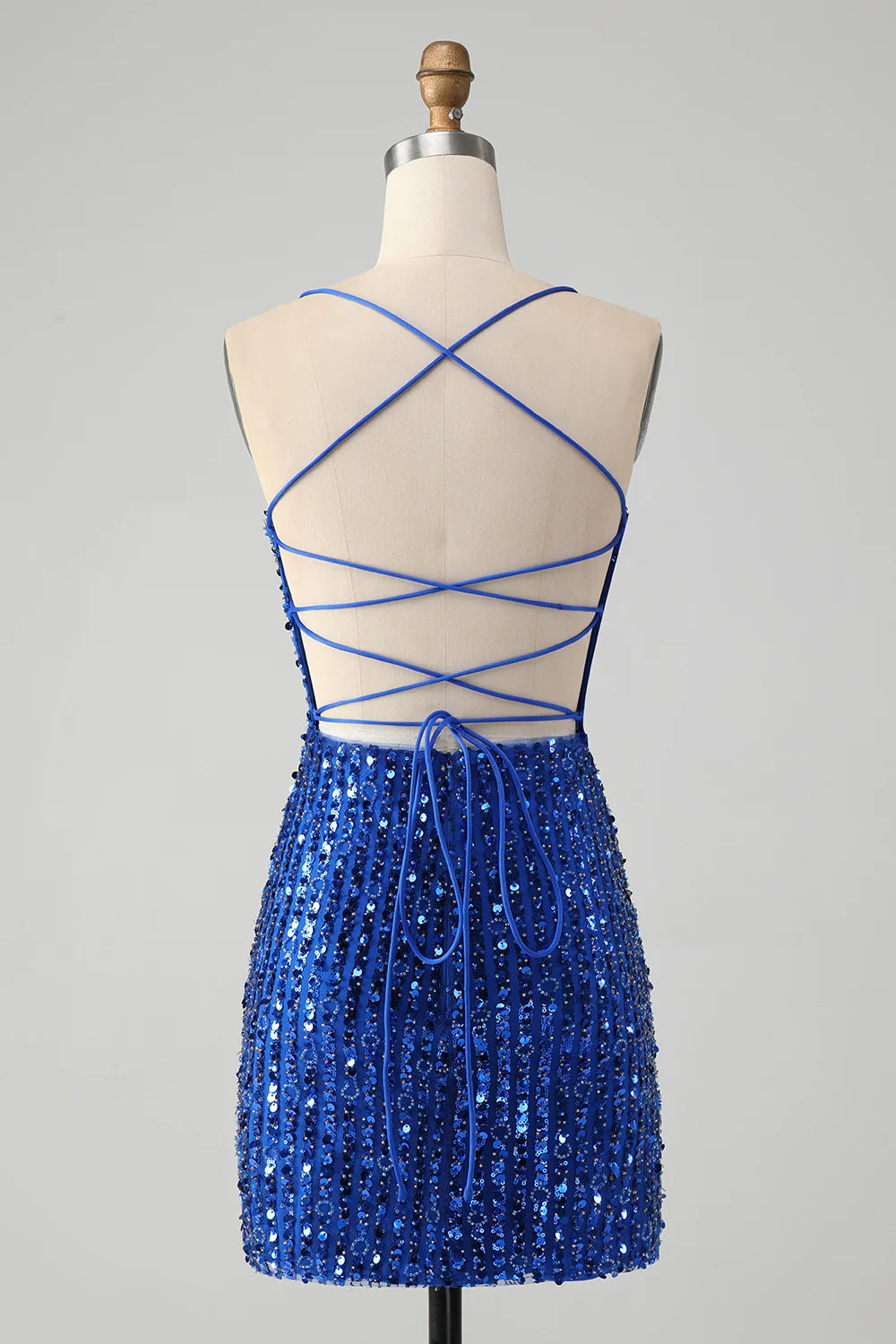 Side view of the royal blue sequin dress, highlighting its short length.
