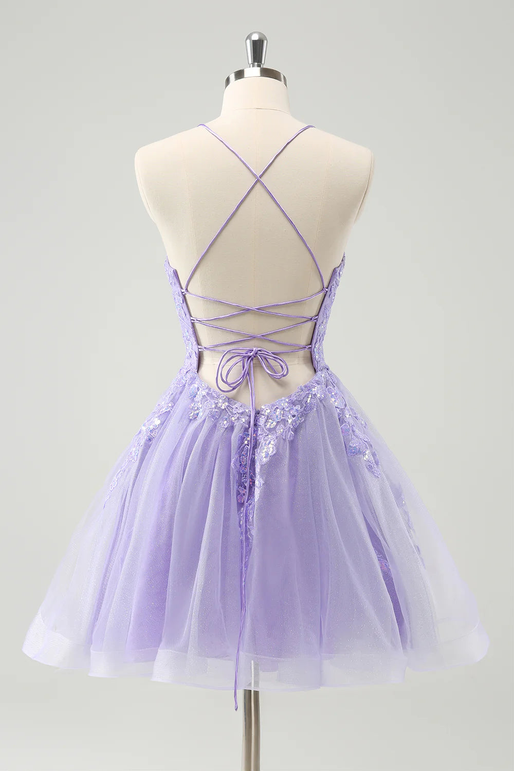 Sparkly lilac A-line sequin short homecoming dress with spaghetti straps and lace-up back, side view.