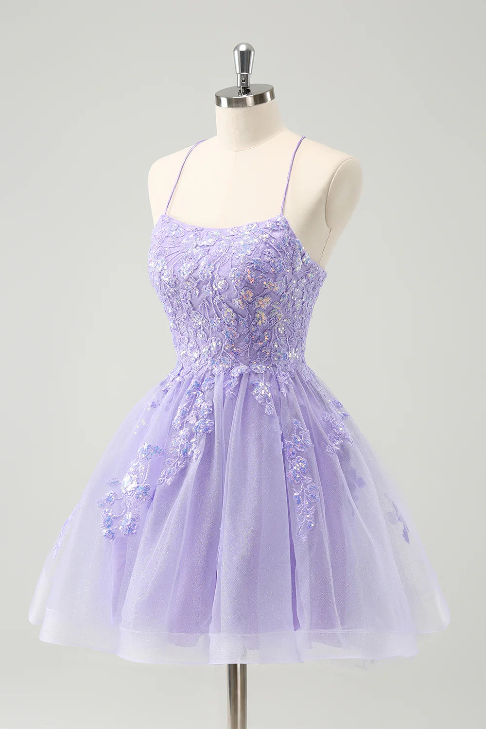 Sparkly lilac A-line sequin short homecoming dress with spaghetti straps and lace-up back, back view.
