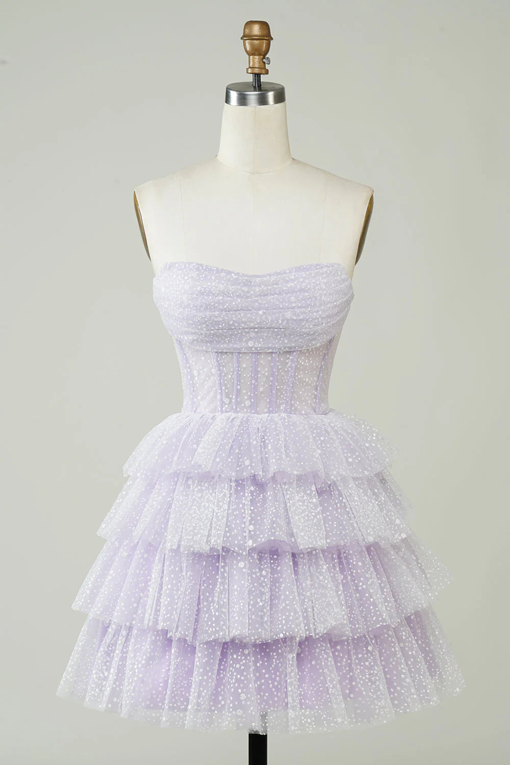 Sparkly lilac A-line strapless homecoming dress with polka dots and tiered skirt.