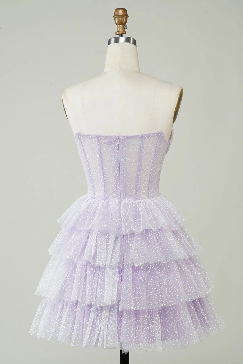 Back view of a sparkly lilac strapless tiered homecoming dress.