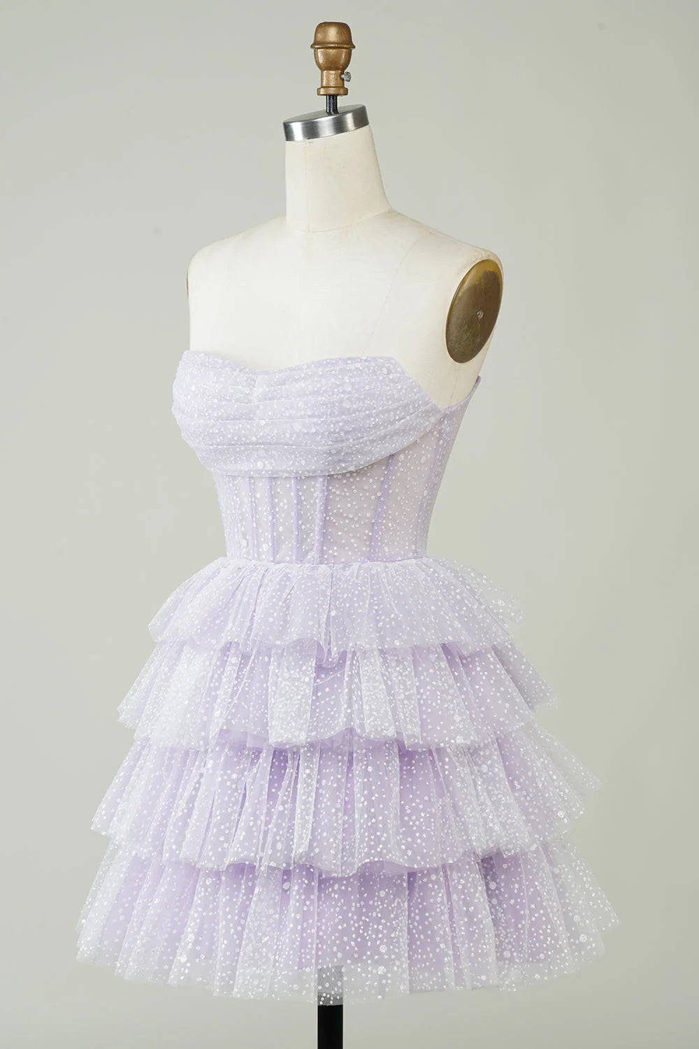 Close-up of the sparkly lilac polka dot fabric on a tiered dress.