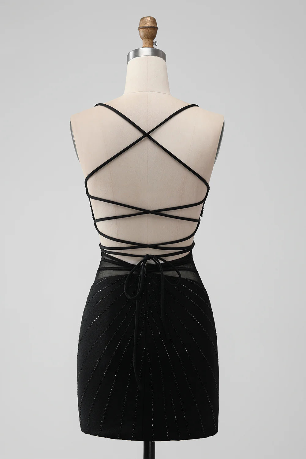 Back view of a black mermaid homecoming dress showing lace-up detail.