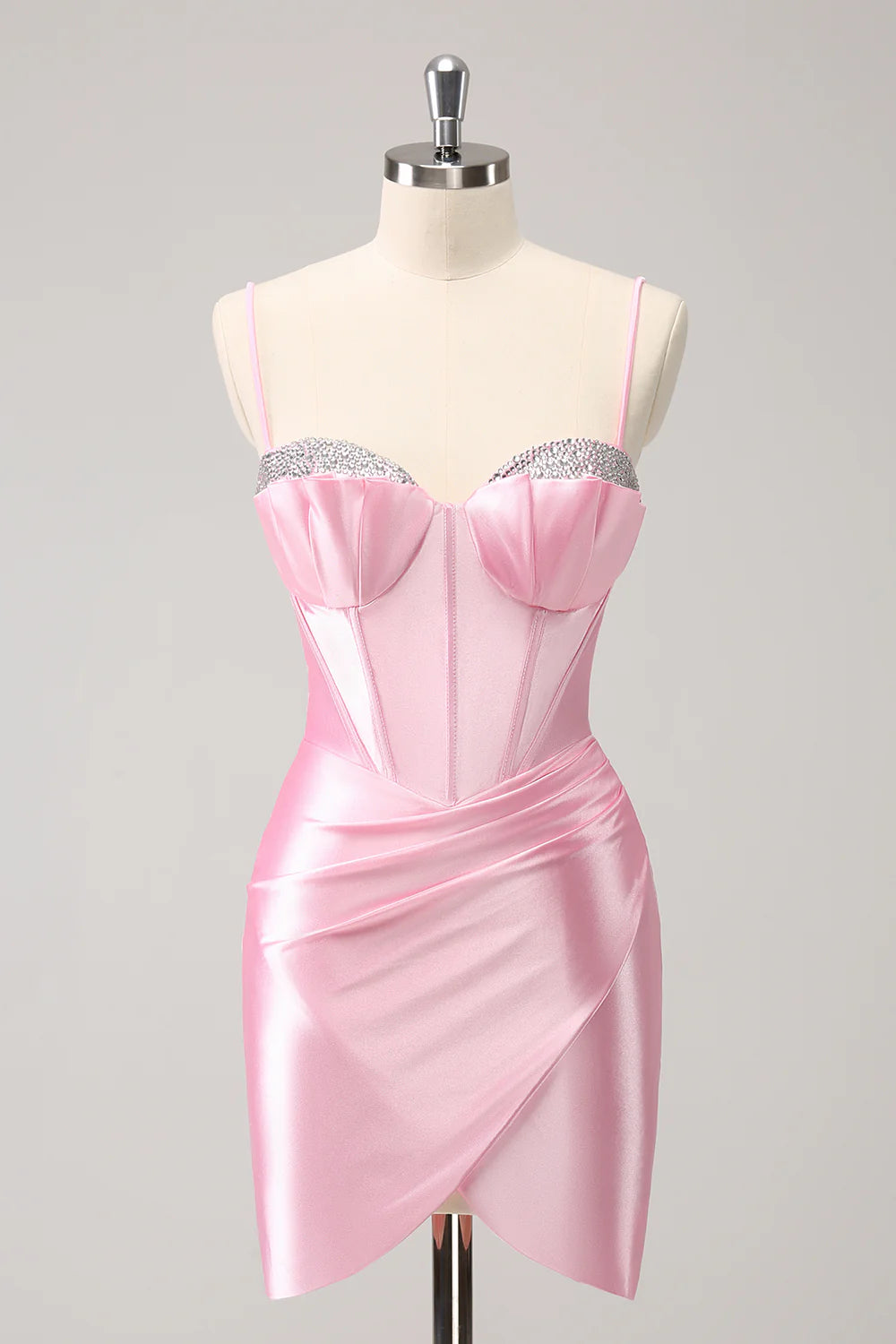 Sparkly pink short homecoming dress with spaghetti straps and beading.