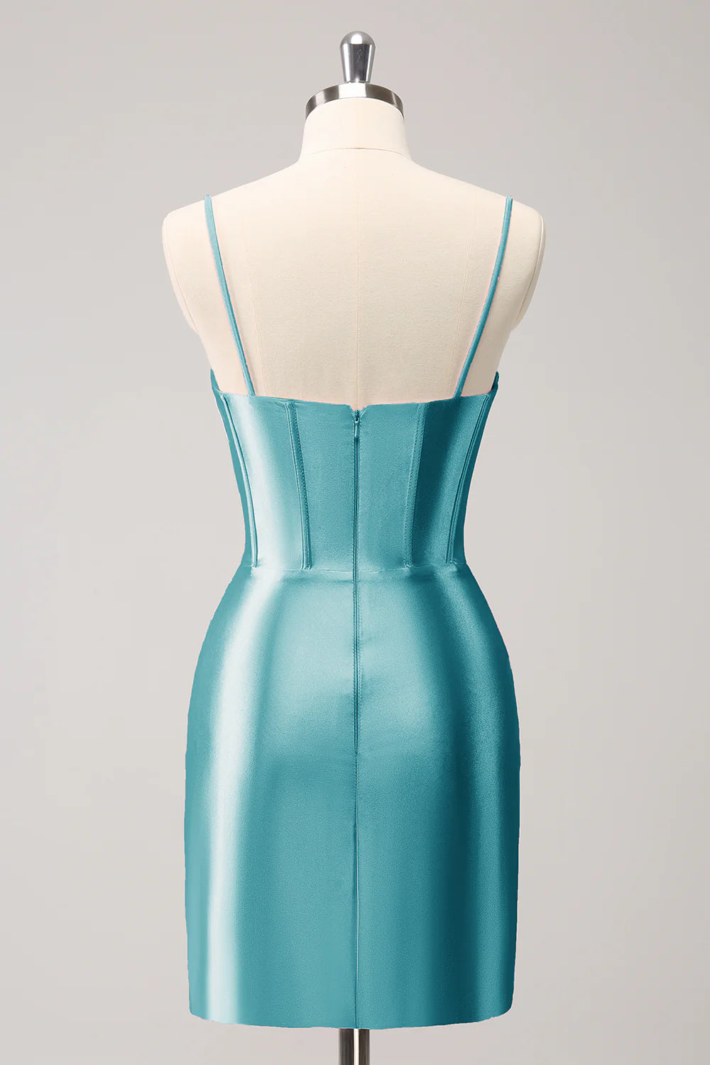 Close-up of peacock blue pleated short homecoming dress fabric.