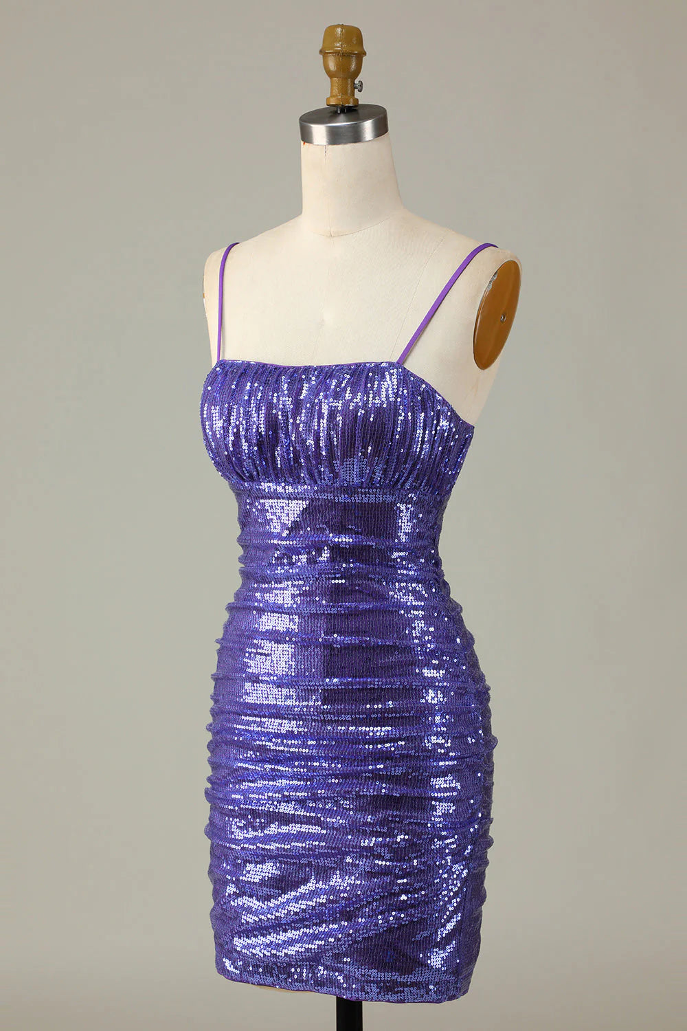 Close-up of the sparkly purple sequin fabric on the short dress.