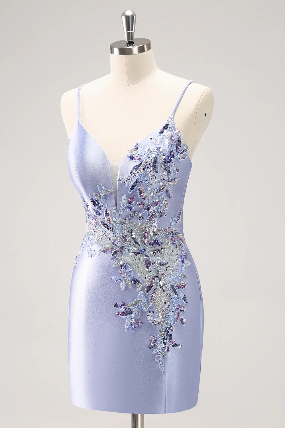 Close-up of the beaded spaghetti straps and sequin detail on the blue homecoming dress.
