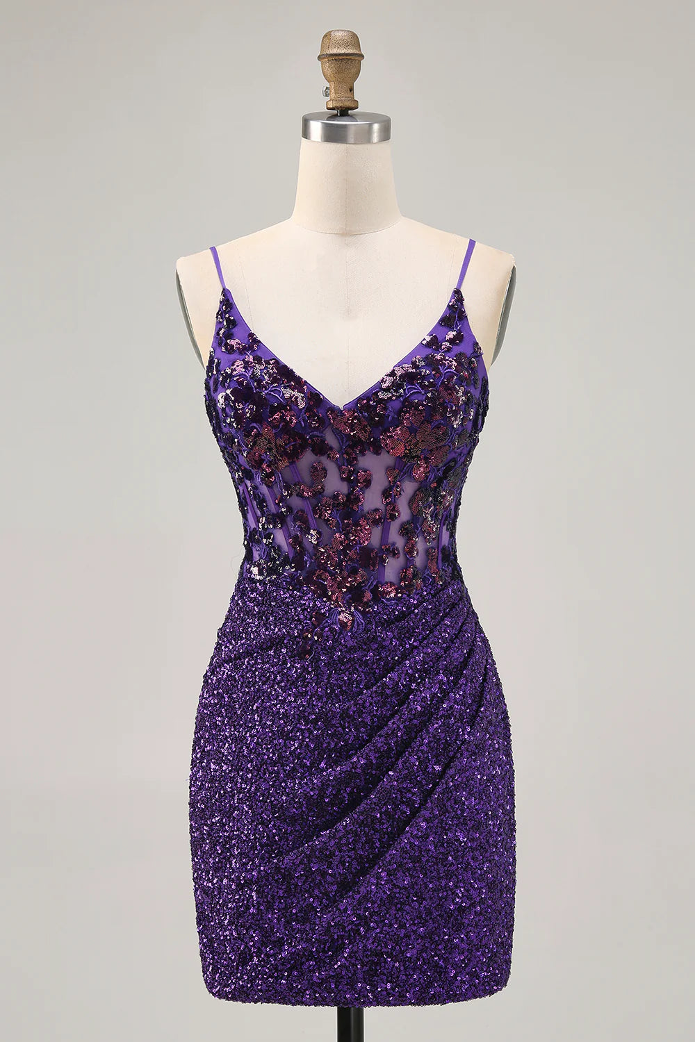 Model wearing a sparkly dark purple sequin bodycon short homecoming dress with a corset bodice.