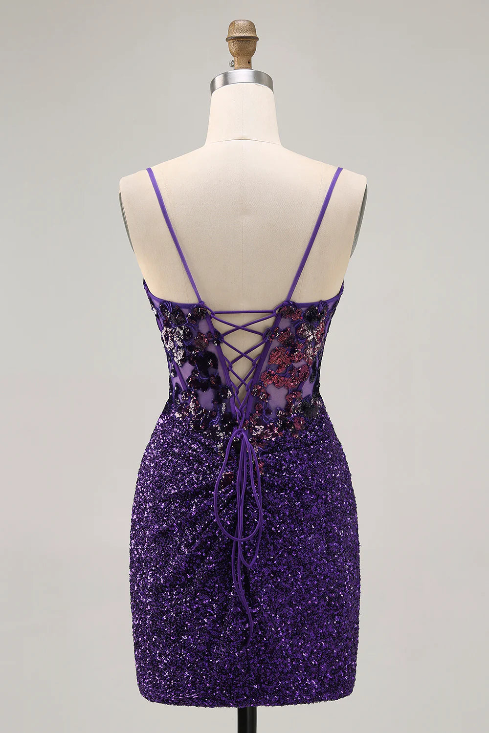 Side view of a model in a dark purple sequin short bodycon dress, showcasing the fitted silhouette.