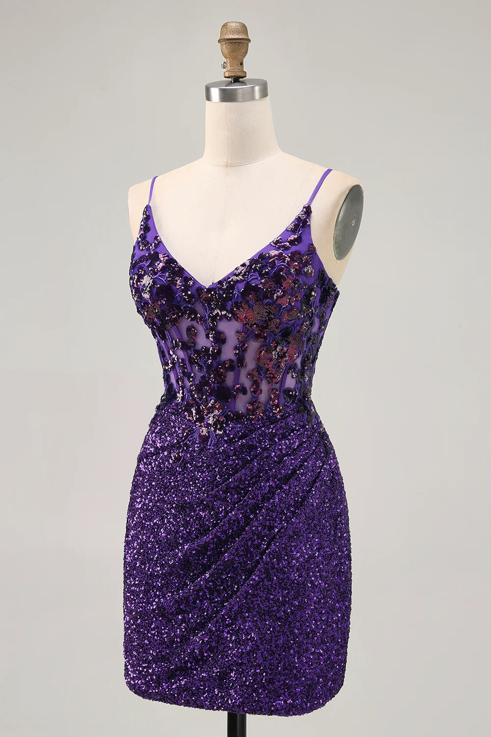 Back view of a model in a sparkly dark purple sequin homecoming dress, highlighting the sequin detail.