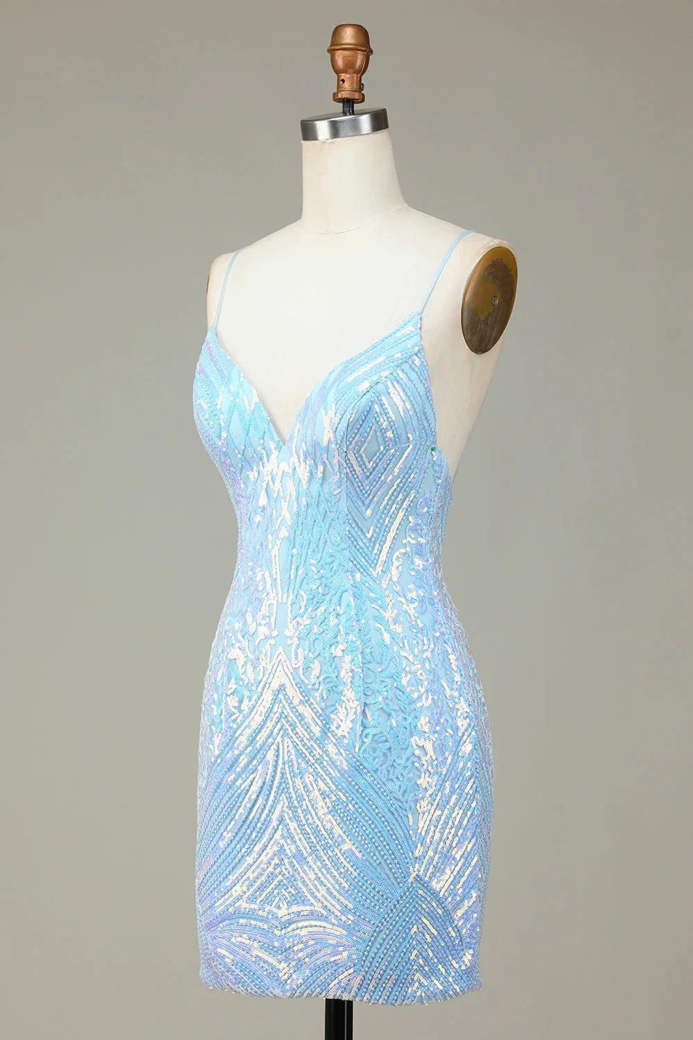 Model posing in the sparkly blue sequin dress, showing the full design.