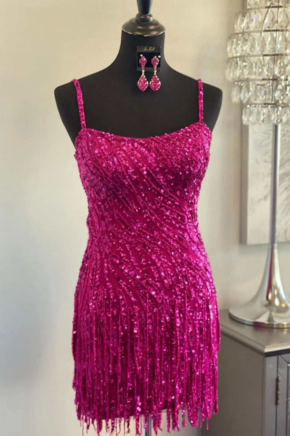 Sparkly sequin short homecoming dress with spaghetti straps and fringe detail.