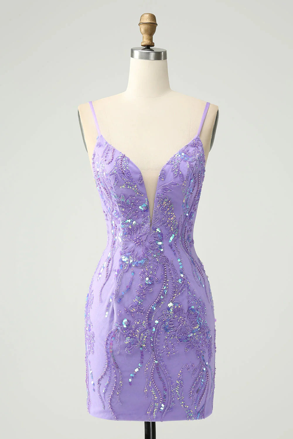 Model wearing a sparkly purple short homecoming dress with sequins.