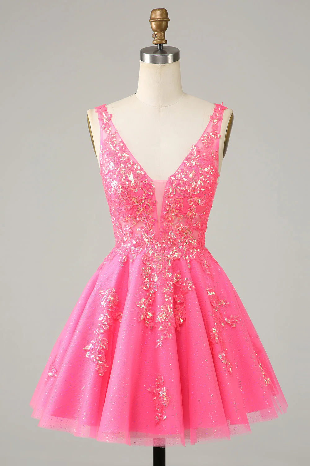 Model wearing a sparkly fuchsia sequined V-neck short homecoming dress.