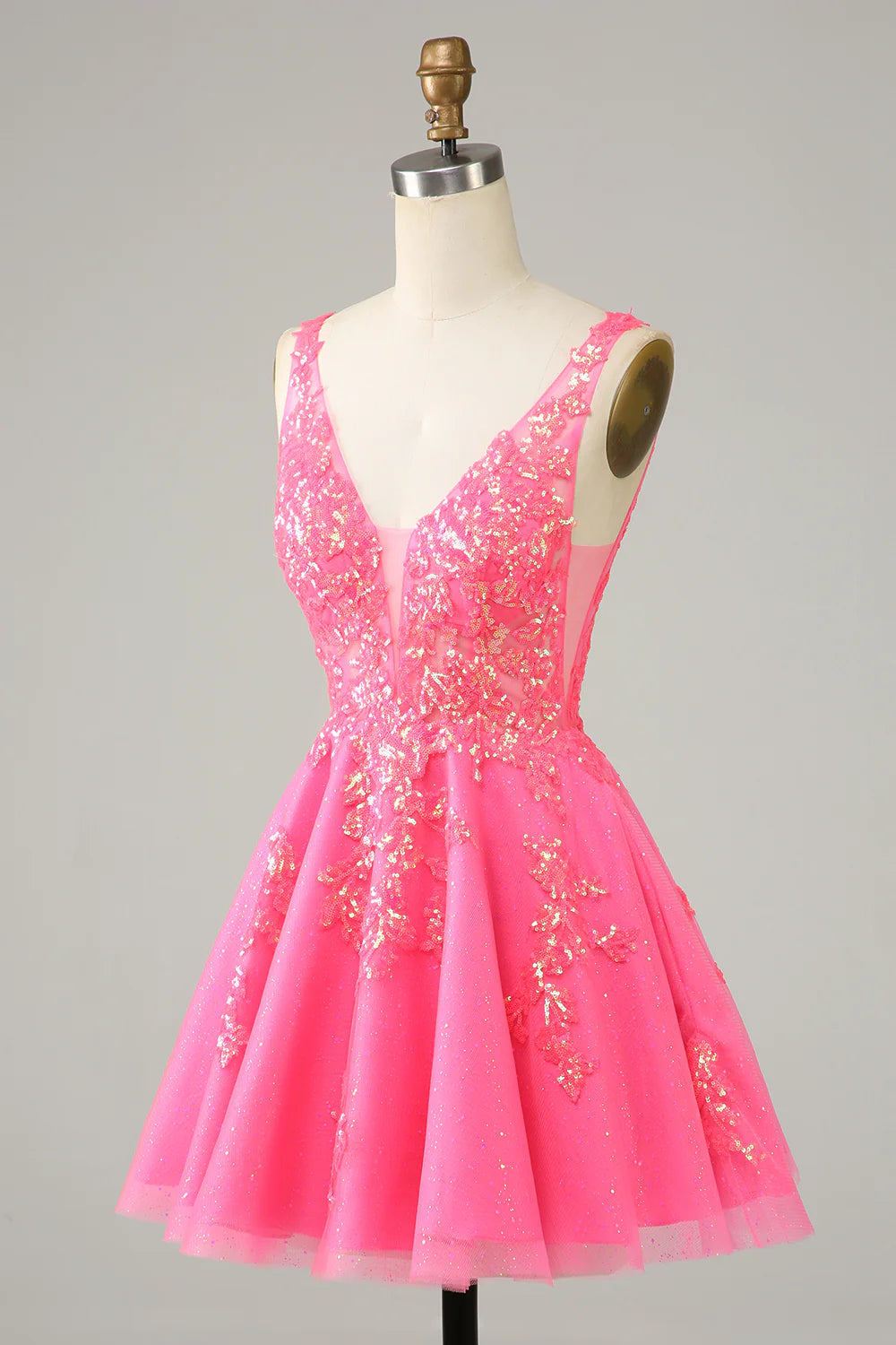 Side view of a sparkly fuchsia sequined V-neck short homecoming dress.