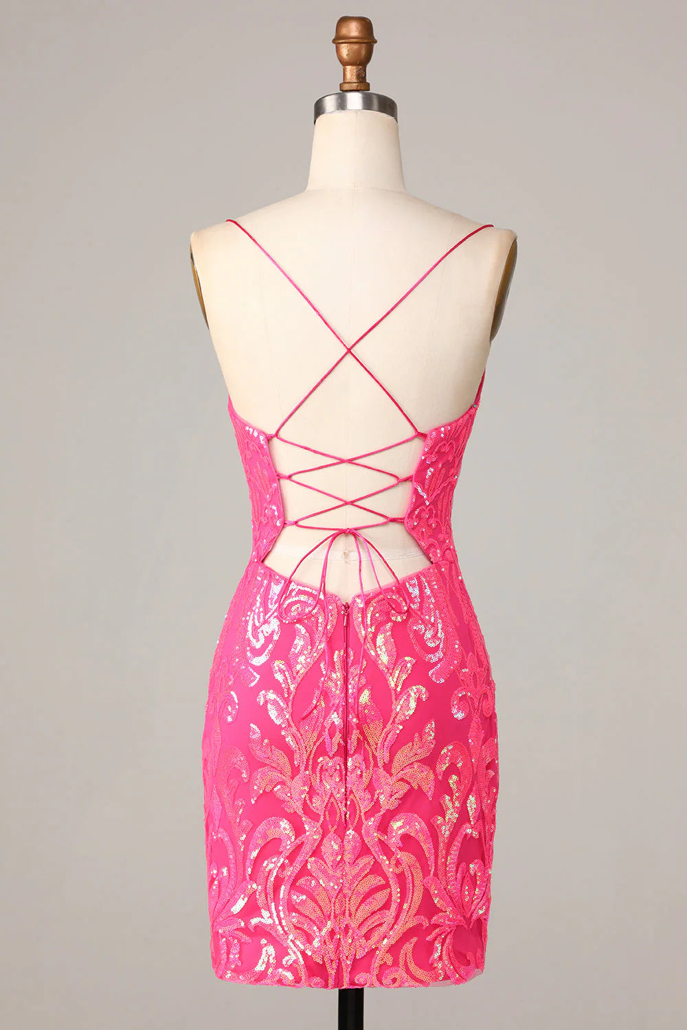 Side view of a sparkly hot pink sequin sheath dress with spaghetti straps.