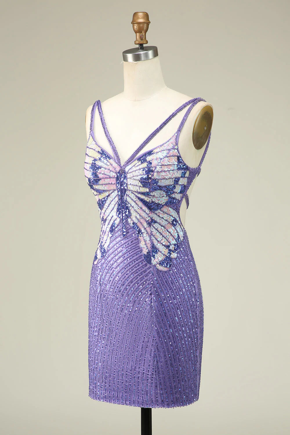 Close-up of sparkly purple sequin fabric on a short dress.