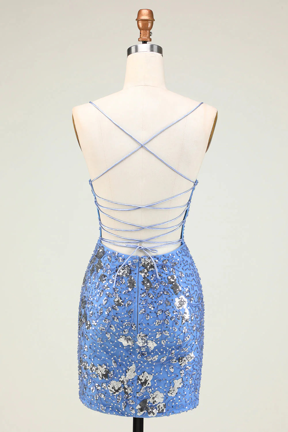 Back view of grey blue sequined short dress showing criss-cross straps.