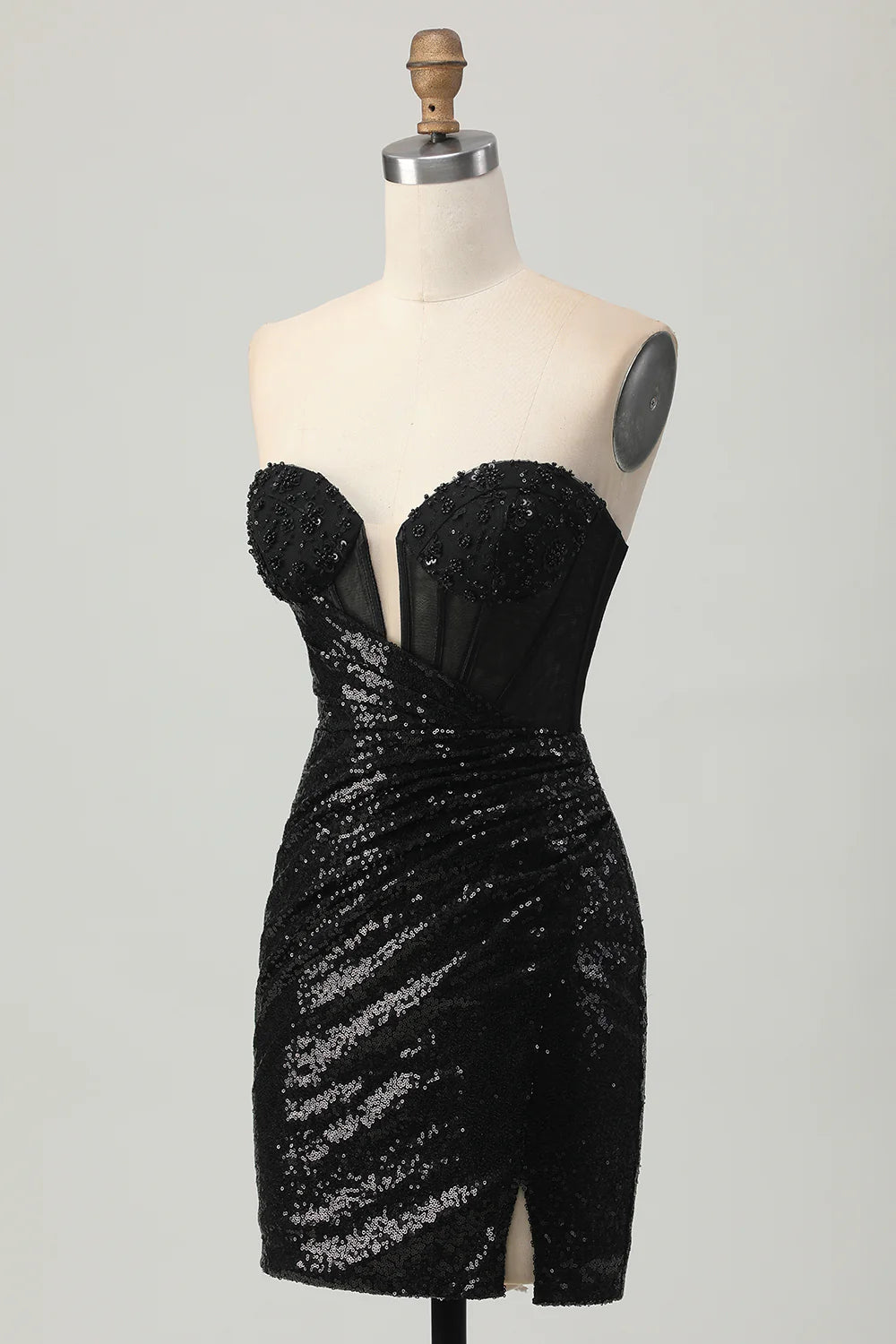 Close-up of the sequin fabric and slit detail on a black homecoming dress.