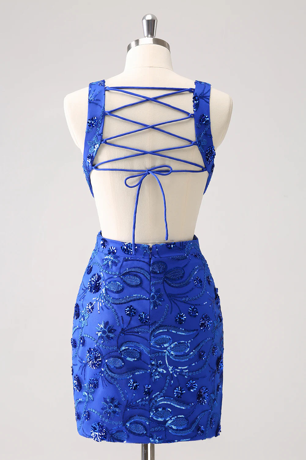Back view of the royal blue sequin dress, highlighting the adjustable lace-up closure.