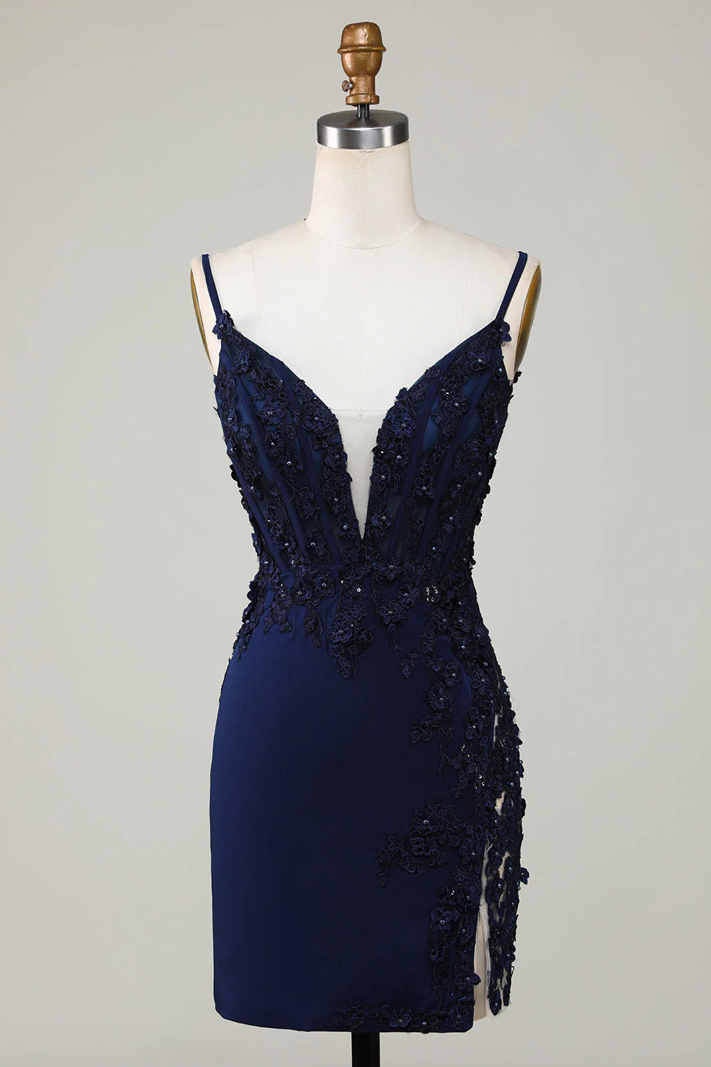 Model wearing a sparkly navy short homecoming dress with a sweetheart neckline and lace details.