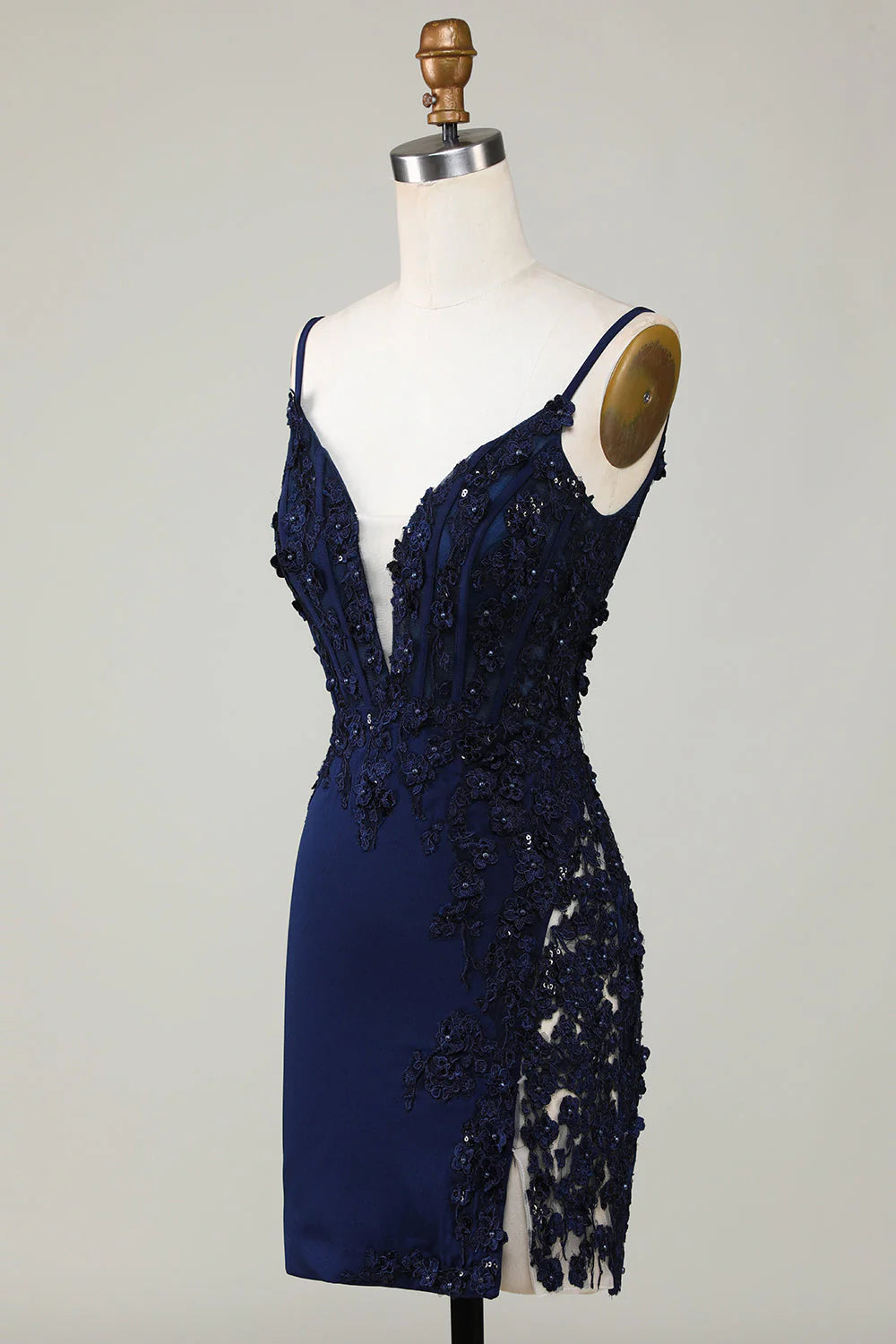 Close-up of the sparkly navy fabric and delicate lace on the short homecoming dress.