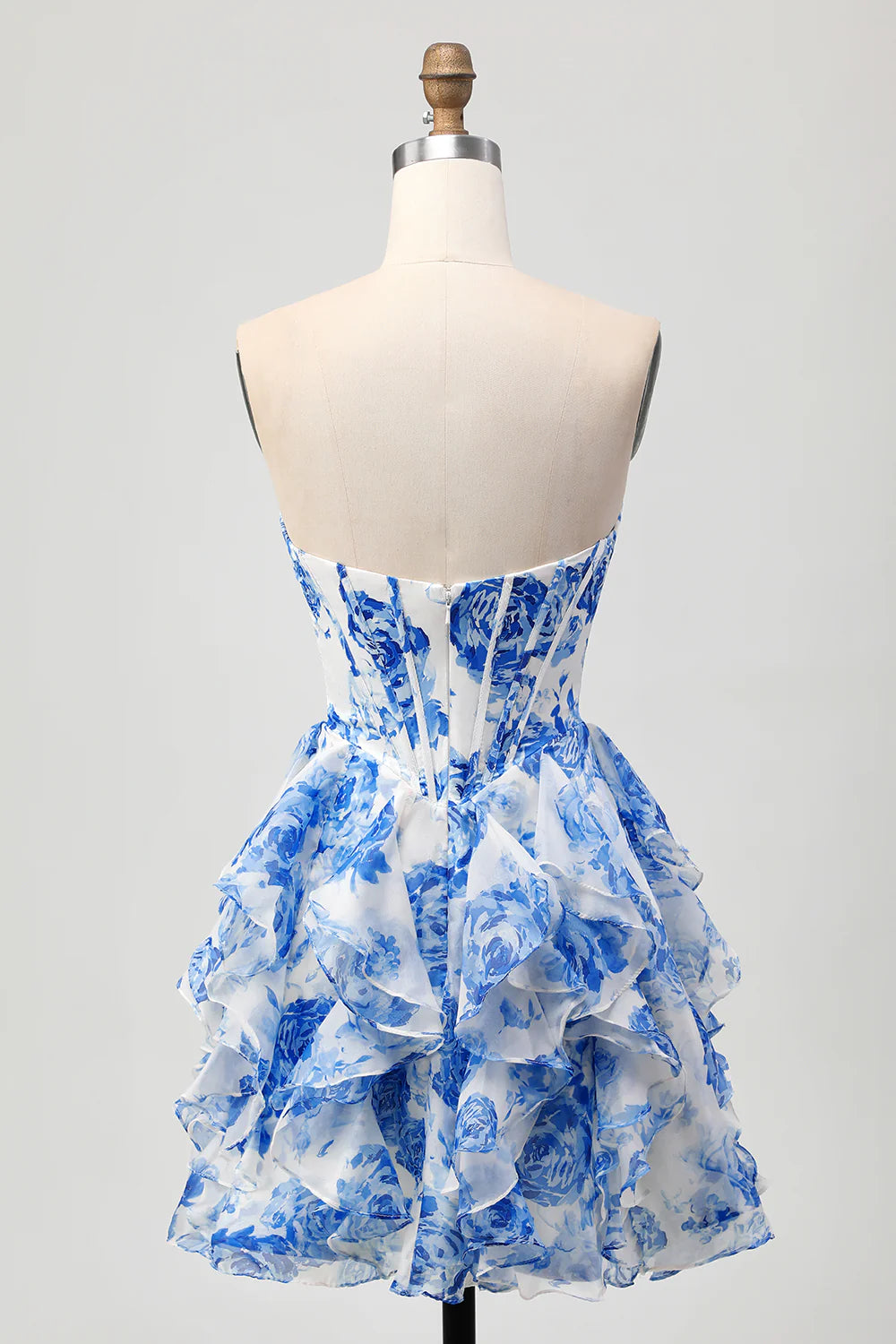 Side view of the tiered white and blue floral homecoming dress, showing the bow detail.