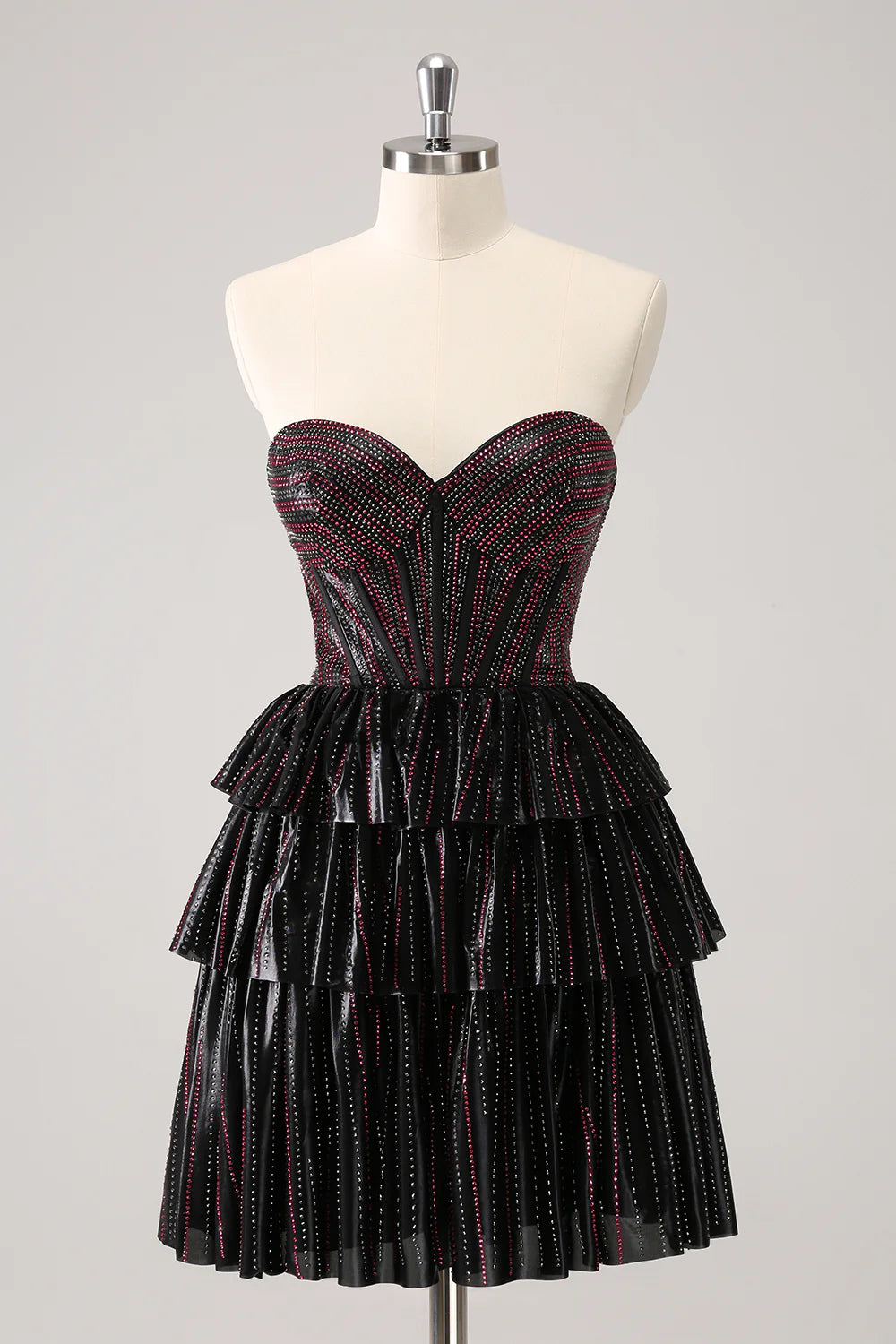Front view of a black and pink A-line sweetheart corset homecoming dress with beading.