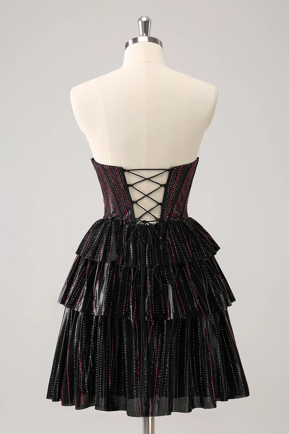 Side view of the black and pink A-line sweetheart corset homecoming dress.