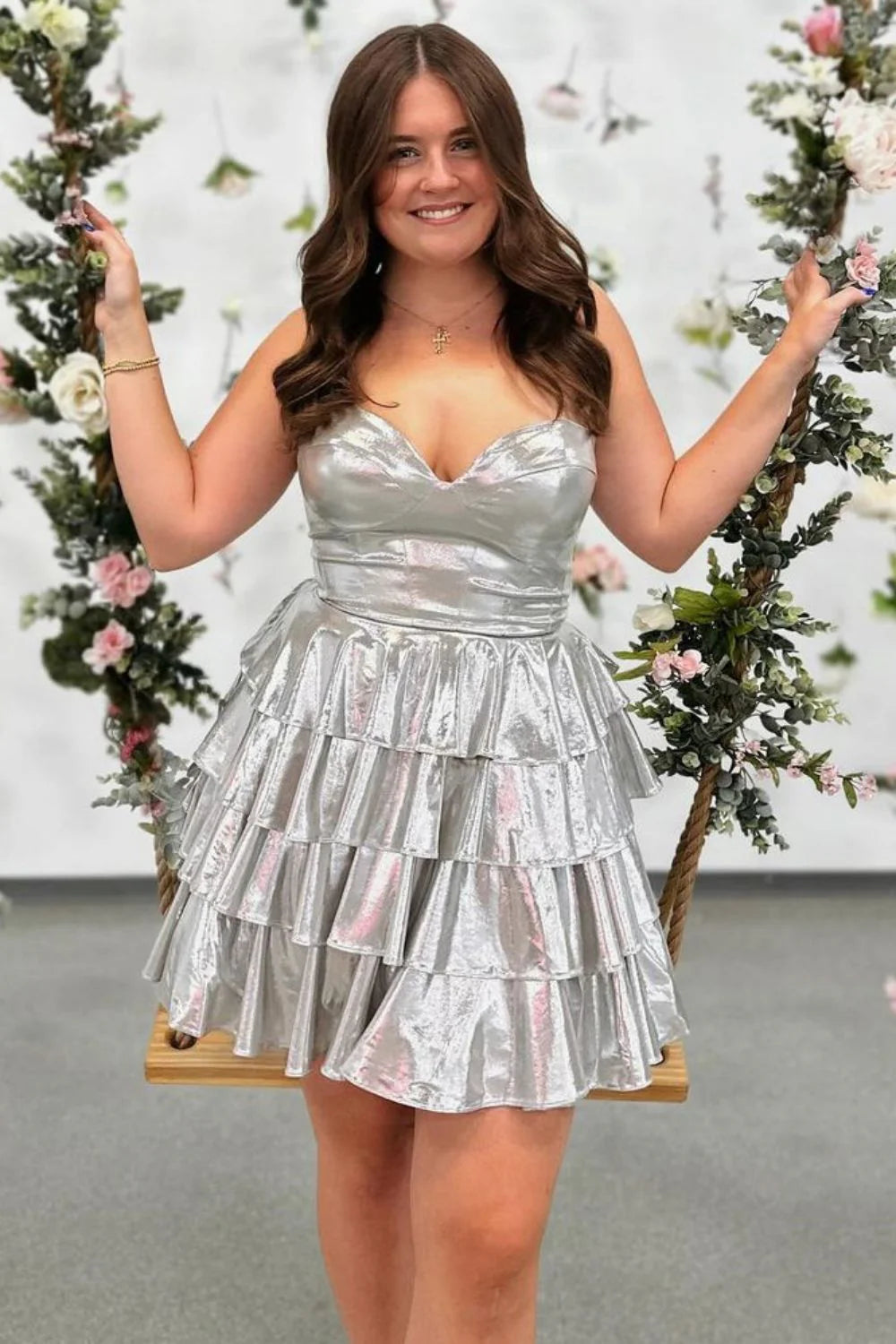 Model wearing a gold A-Line sweetheart tiered metallic short homecoming dress.