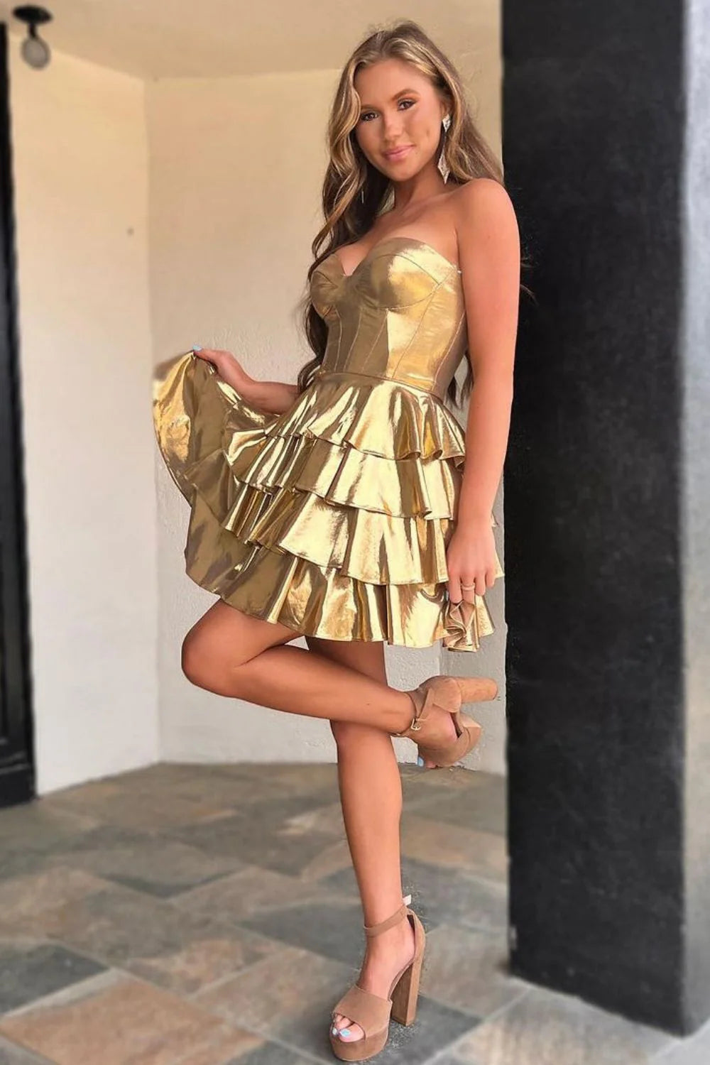 Close-up of the tiered metallic fabric on a gold homecoming dress.
